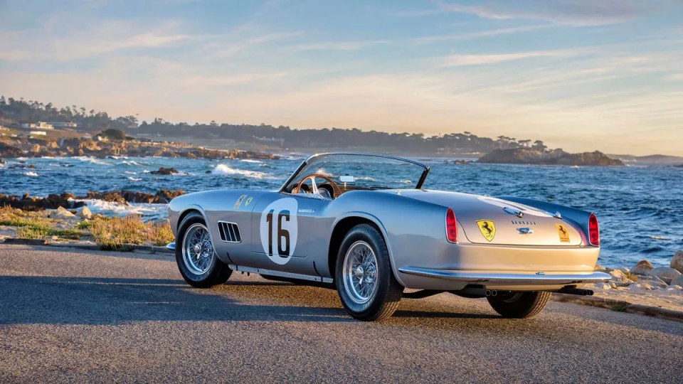 Silver 1959 Ferrari 250 GT California Spider by the ocean.