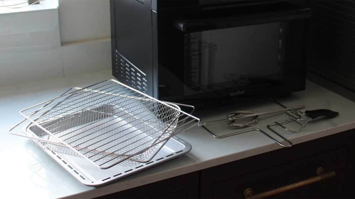 Cooking trays, racks and rotisserie in front of the appliance