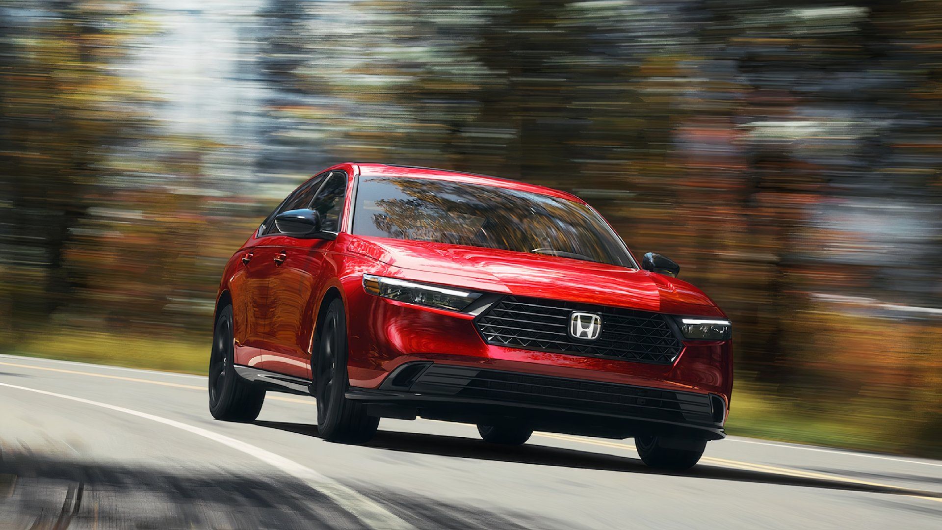 A red 2024 Honda Accord Hybrid midsize hybrid car is driving. 