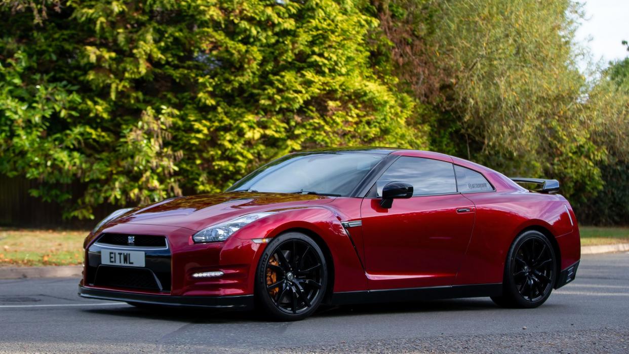 Whittlebury,Northants,UK - August 28th 2022. 2012 red  3799 cc Nissan GTR car driving on an English country road