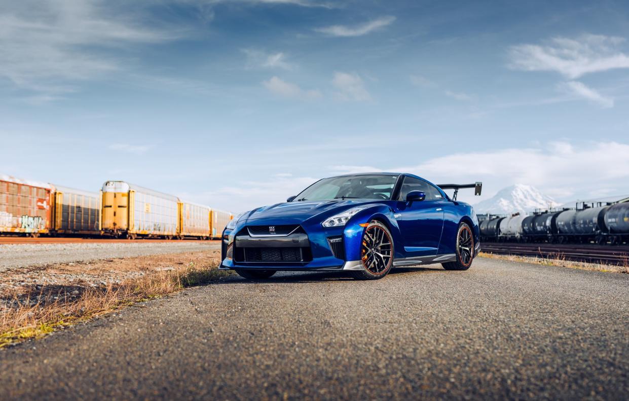 Seattle, WA, USA4/18/2022Blue Nissan R35 GTR parked with trains in the background