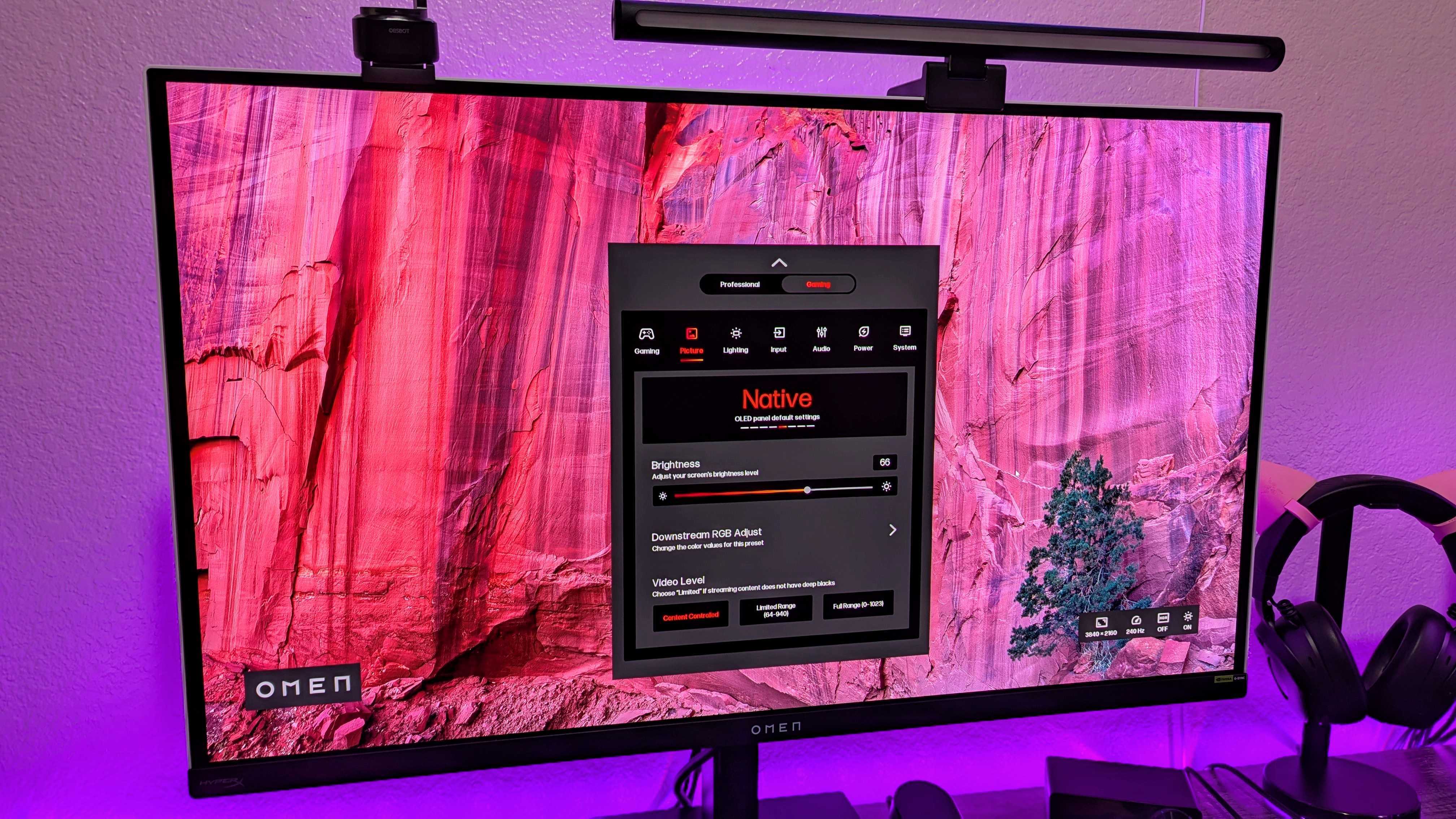 The HP OMEN Transcend 32 on a desk, showing its OSD.