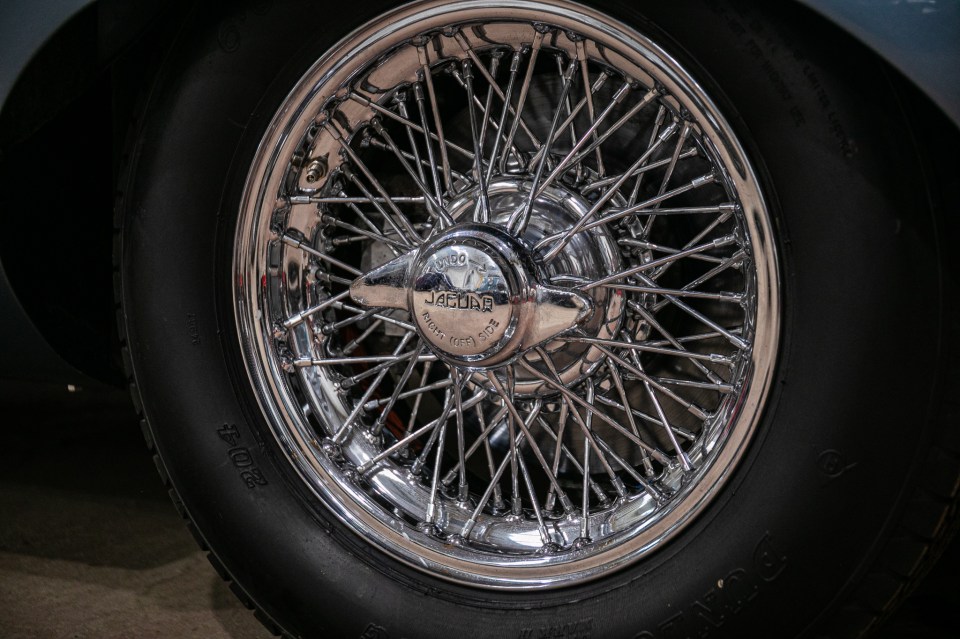 Close-up of a chrome wire wheel on a Jaguar E-Type.