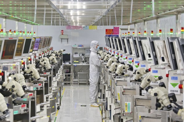 A man works at a manufacturer of Integrated Chip encapsulation in Nantong in eastern China's Jiangsu province on Friday, Sept. 16, 2022. (Chinatopix Via AP, File)