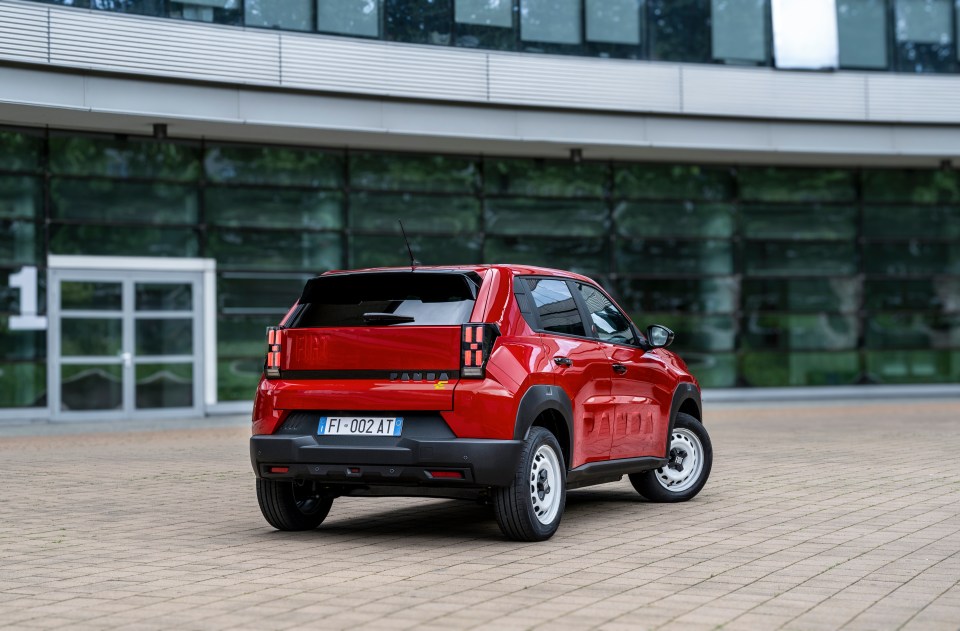 Rear view of a red Fiat Panda electric car.