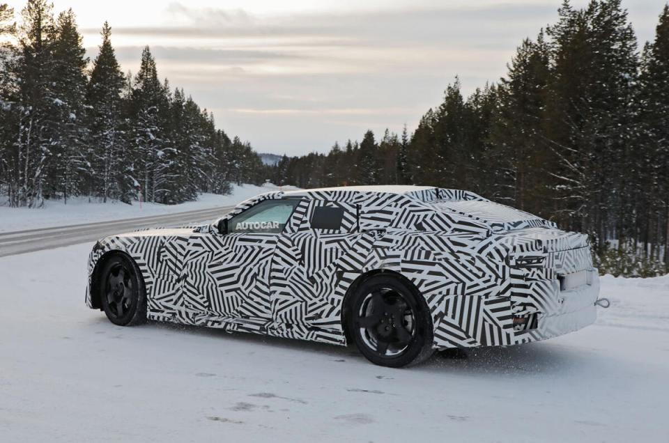 Rear view of a camouflaged car in the snow.