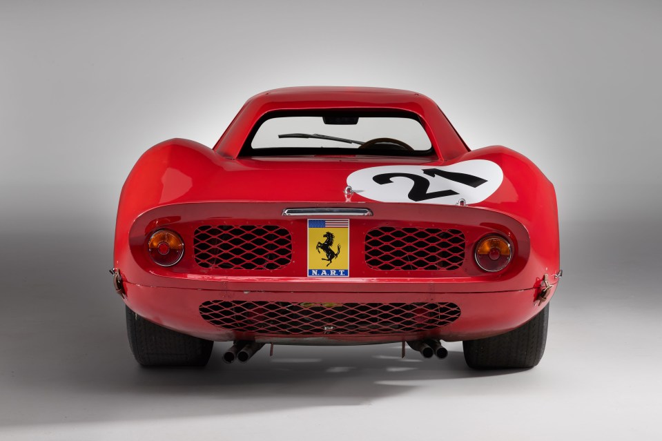 Rear view of a red 1964 Ferrari 250 LM race car, number 21.