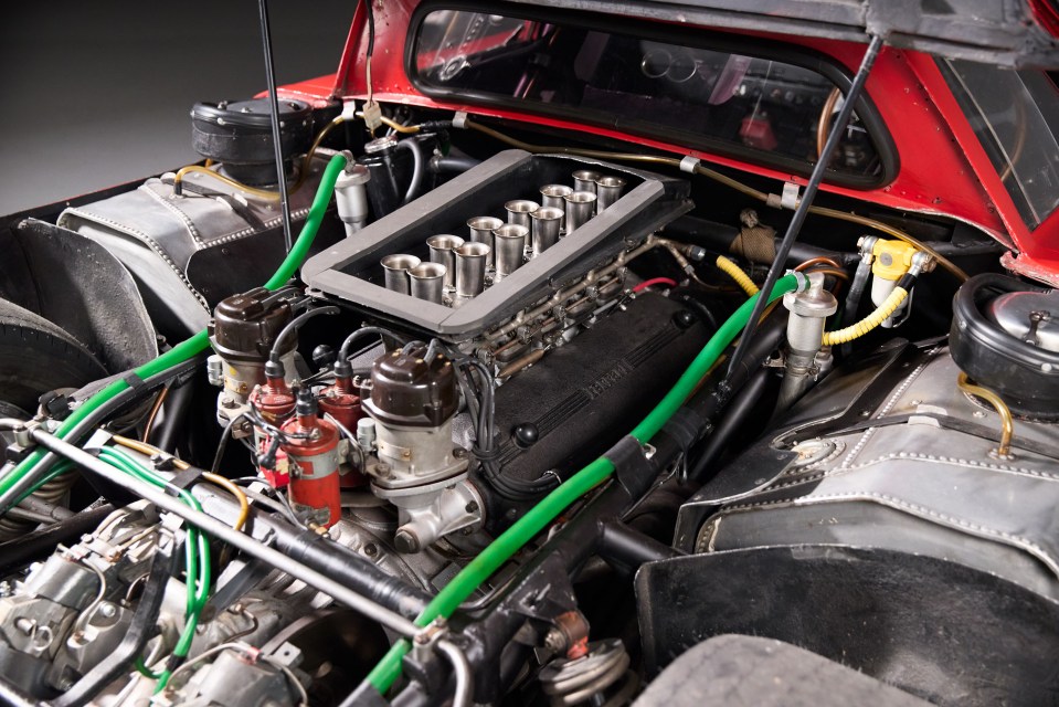 Detailed view of the engine of a 1965 Ferrari 250 LM race car.