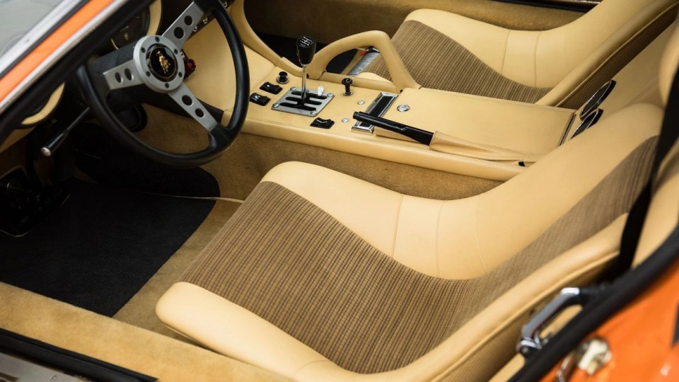 The plush interior, USA, YOU COULD OWN this rare 1971 Lamborghini Miura P400 SV for ¿4M at auction. Images show this stunning Lamborghini finished in a unique combination of Arancio Miura or Miura Orange paintwork over a retro Goby sand interior. The Miura SV is one of only about 150 of its kind ever built, making it an incredibly rare find for collectors. One of the first 25 cars built, this Miura features early design elements such as the absence of ¿ears¿ on the wheel spinners and bodywork slats with rounded edges, marking it as a distinctive early example of the SV. This particular model is further distinguished by its European specification, devoid of U.S. specific safety features like side repeaters, and it is equipped with a matching numbers chassis and engine. Chassis No. 4854 and Engine No. 30647 trace a fascinating history, beginning with its delivery in July 1971 to Hubert Hahne, a renowned German racing driver and Lamborghini agent. This Miura has an illustrious provenance, having been part of the Rosso Bianco Collection for over three decades, where it shared space with some of the finest sports cars in the world. The car¿s remarkable journey included ownership by notable figures, such as former racing driver Peter Kaus. The meticulous nut-and-bolt restoration took place between 2014 and 2016 and cost close to ¿250K. It was carried out by award-winning Modenese Lamborghini experts, including Carrozzeria Cremonini handling the bodywork and Top Motors working on the mechanicals, alongside other industry leaders. The 1971 Lamborghini Miura P400 SV is set to be auctioned at The Amelia Auction in 2025. ¿The car's striking original colours were briefly altered, as records show it was painted in Luci del Bosco Green before its first private owner, but it has since been restored to its original Miura Orange exterior. "By the early 1980s, the car was acquired by former racing driver and renowned collector Peter Kaus," who added it to his world-famous collection. ¿During this time, the car showed around 60,000 kilometers, believed to be original, before it was sold and carefully restored. "Any Miura SV is a rare motorcar. ¿But an SV such as this, restored to its original and correct specification by the very best craftsmen in Modena, is truly a rare opportunity." ENDS