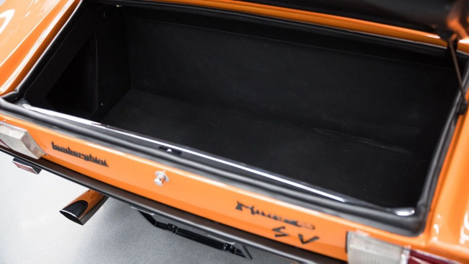 The boot, USA, YOU COULD OWN this rare 1971 Lamborghini Miura P400 SV for ¿4M at auction. Images show this stunning Lamborghini finished in a unique combination of Arancio Miura or Miura Orange paintwork over a retro Goby sand interior. The Miura SV is one of only about 150 of its kind ever built, making it an incredibly rare find for collectors. One of the first 25 cars built, this Miura features early design elements such as the absence of ¿ears¿ on the wheel spinners and bodywork slats with rounded edges, marking it as a distinctive early example of the SV. This particular model is further distinguished by its European specification, devoid of U.S. specific safety features like side repeaters, and it is equipped with a matching numbers chassis and engine. Chassis No. 4854 and Engine No. 30647 trace a fascinating history, beginning with its delivery in July 1971 to Hubert Hahne, a renowned German racing driver and Lamborghini agent. This Miura has an illustrious provenance, having been part of the Rosso Bianco Collection for over three decades, where it shared space with some of the finest sports cars in the world. The car¿s remarkable journey included ownership by notable figures, such as former racing driver Peter Kaus. The meticulous nut-and-bolt restoration took place between 2014 and 2016 and cost close to ¿250K. It was carried out by award-winning Modenese Lamborghini experts, including Carrozzeria Cremonini handling the bodywork and Top Motors working on the mechanicals, alongside other industry leaders. The 1971 Lamborghini Miura P400 SV is set to be auctioned at The Amelia Auction in 2025. ¿The car's striking original colours were briefly altered, as records show it was painted in Luci del Bosco Green before its first private owner, but it has since been restored to its original Miura Orange exterior. "By the early 1980s, the car was acquired by former racing driver and renowned collector Peter Kaus," who added it to his world-famous collection. ¿During this time, the car showed around 60,000 kilometers, believed to be original, before it was sold and carefully restored. "Any Miura SV is a rare motorcar. ¿But an SV such as this, restored to its original and correct specification by the very best craftsmen in Modena, is truly a rare opportunity." ENDS