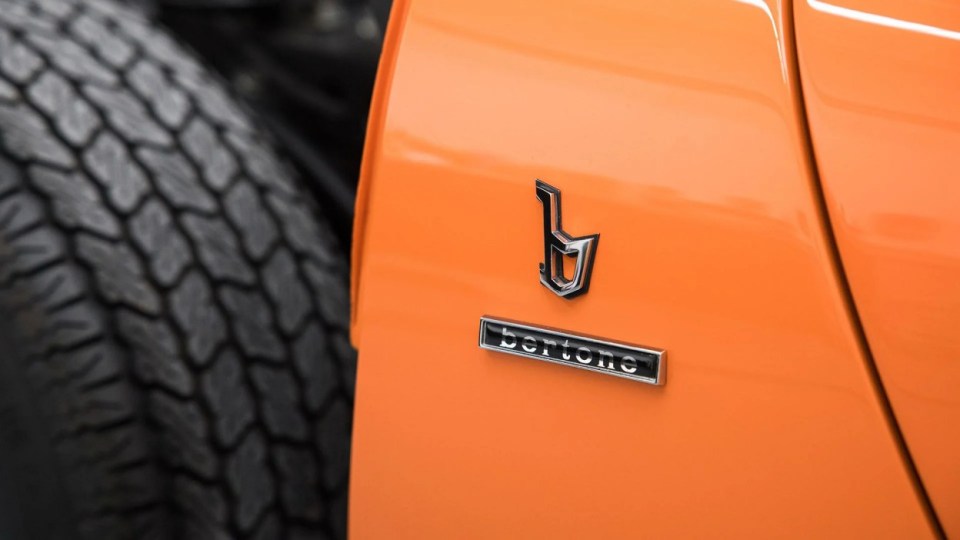 Badges on the Lamborghini exterior, USA, YOU COULD OWN this rare 1971 Lamborghini Miura P400 SV for ¿4M at auction. Images show this stunning Lamborghini finished in a unique combination of Arancio Miura or Miura Orange paintwork over a retro Goby sand interior. The Miura SV is one of only about 150 of its kind ever built, making it an incredibly rare find for collectors. One of the first 25 cars built, this Miura features early design elements such as the absence of ¿ears¿ on the wheel spinners and bodywork slats with rounded edges, marking it as a distinctive early example of the SV. This particular model is further distinguished by its European specification, devoid of U.S. specific safety features like side repeaters, and it is equipped with a matching numbers chassis and engine. Chassis No. 4854 and Engine No. 30647 trace a fascinating history, beginning with its delivery in July 1971 to Hubert Hahne, a renowned German racing driver and Lamborghini agent. This Miura has an illustrious provenance, having been part of the Rosso Bianco Collection for over three decades, where it shared space with some of the finest sports cars in the world. The car¿s remarkable journey included ownership by notable figures, such as former racing driver Peter Kaus. The meticulous nut-and-bolt restoration took place between 2014 and 2016 and cost close to ¿250K. It was carried out by award-winning Modenese Lamborghini experts, including Carrozzeria Cremonini handling the bodywork and Top Motors working on the mechanicals, alongside other industry leaders. The 1971 Lamborghini Miura P400 SV is set to be auctioned at The Amelia Auction in 2025. ¿The car's striking original colours were briefly altered, as records show it was painted in Luci del Bosco Green before its first private owner, but it has since been restored to its original Miura Orange exterior. "By the early 1980s, the car was acquired by former racing driver and renowned collector Peter Kaus," who added it to his world-famous collection. ¿During this time, the car showed around 60,000 kilometers, believed to be original, before it was sold and carefully restored. "Any Miura SV is a rare motorcar. ¿But an SV such as this, restored to its original and correct specification by the very best craftsmen in Modena, is truly a rare opportunity." ENDS