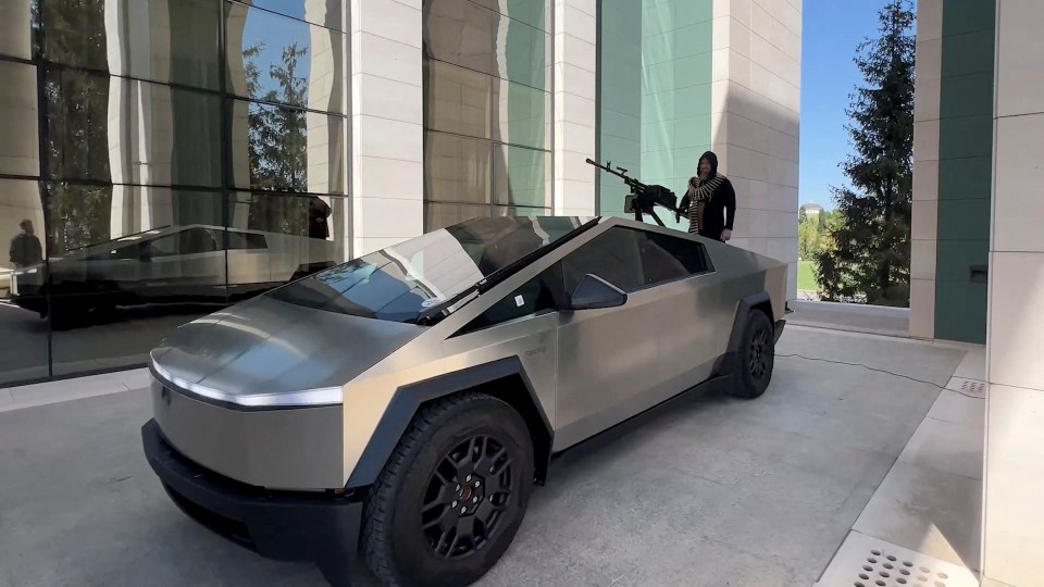 Ramzan Kadyrov standing next to a Tesla Cybertruck with a mounted machine gun.