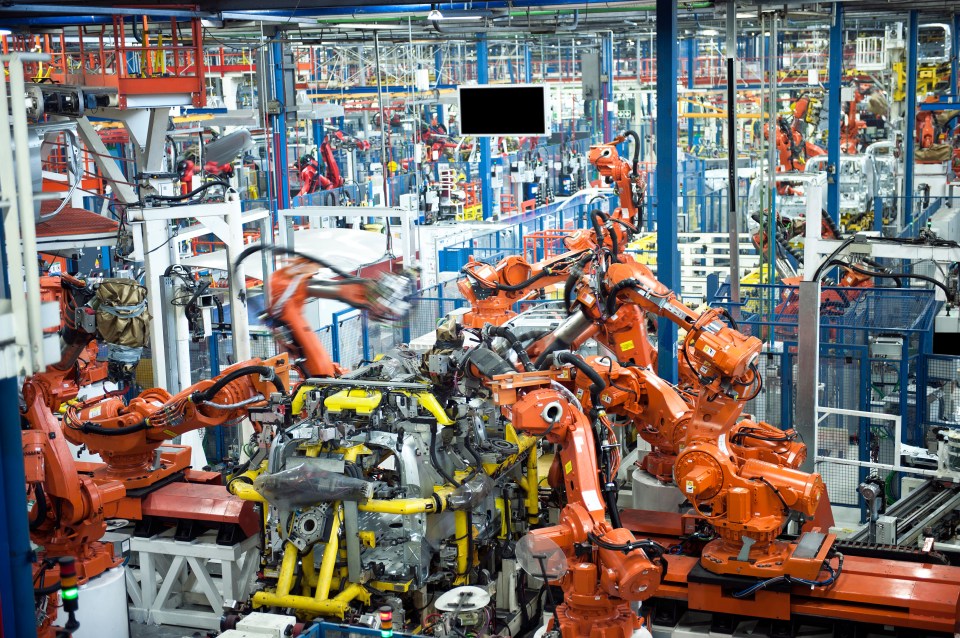 Factory robots assembling a car.