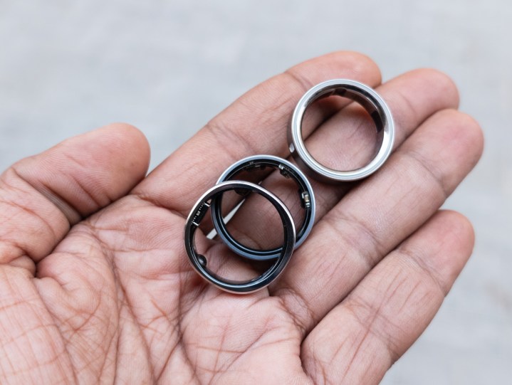 Oura Ring 4, Galaxy Ring and RingConn Gen 2 in the palm of a hand