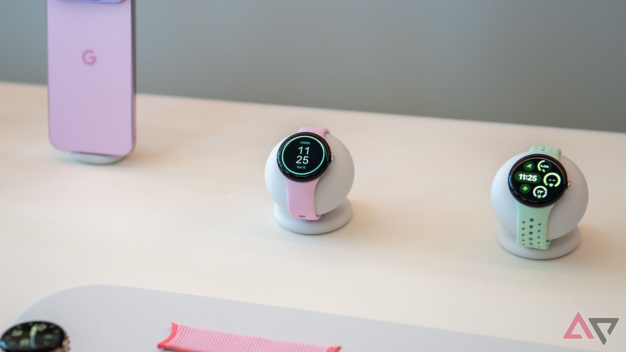 Two pixel watch 3 with pink and green bands on a table