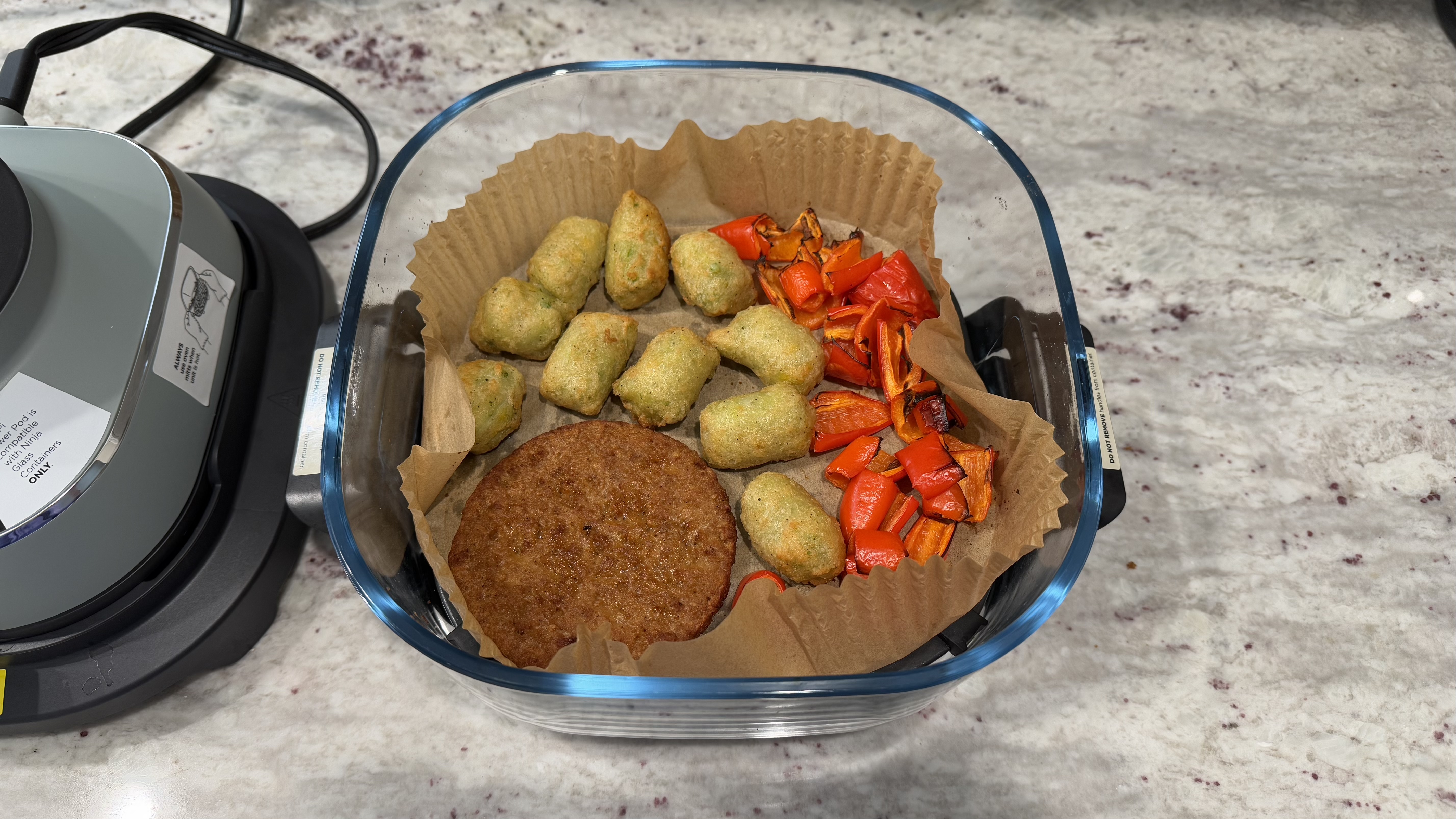 Ninja Crispi with air fried veggie burger, veggie tots, and red peppers