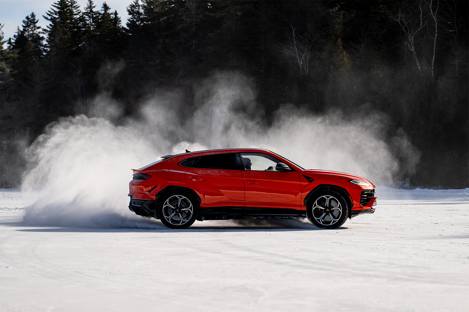 The Lamborghini Urus SE driving on a frozen lake