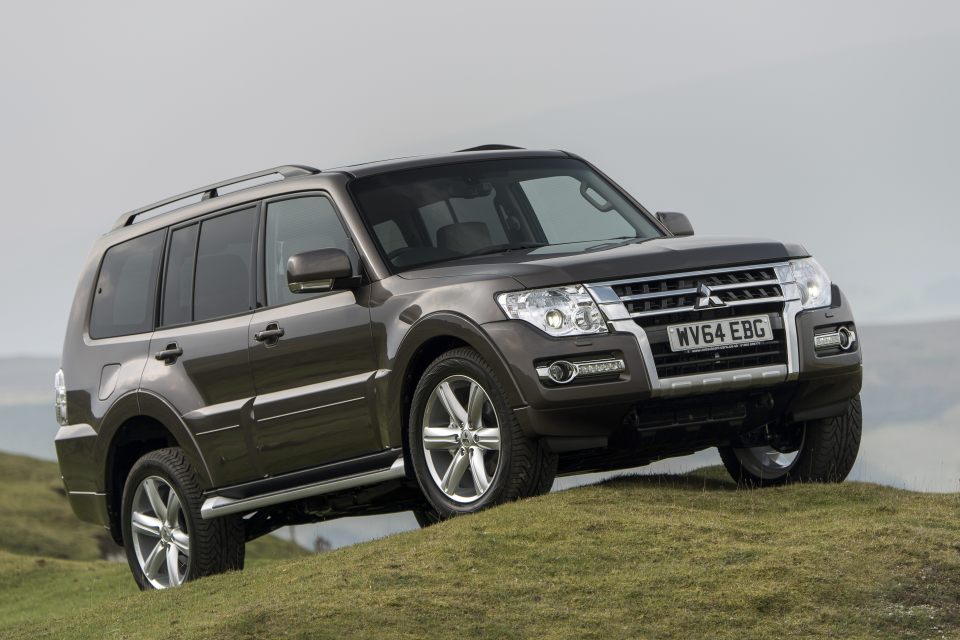 Mitsubishi Shogun LWB SG4 driving on a grassy hill.