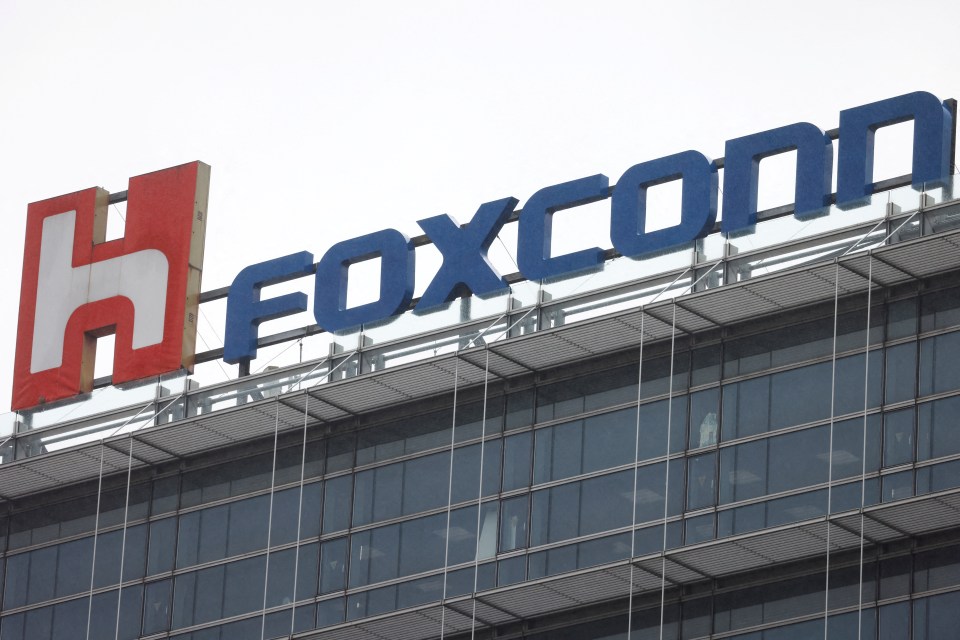 Foxconn logo on a building at night.