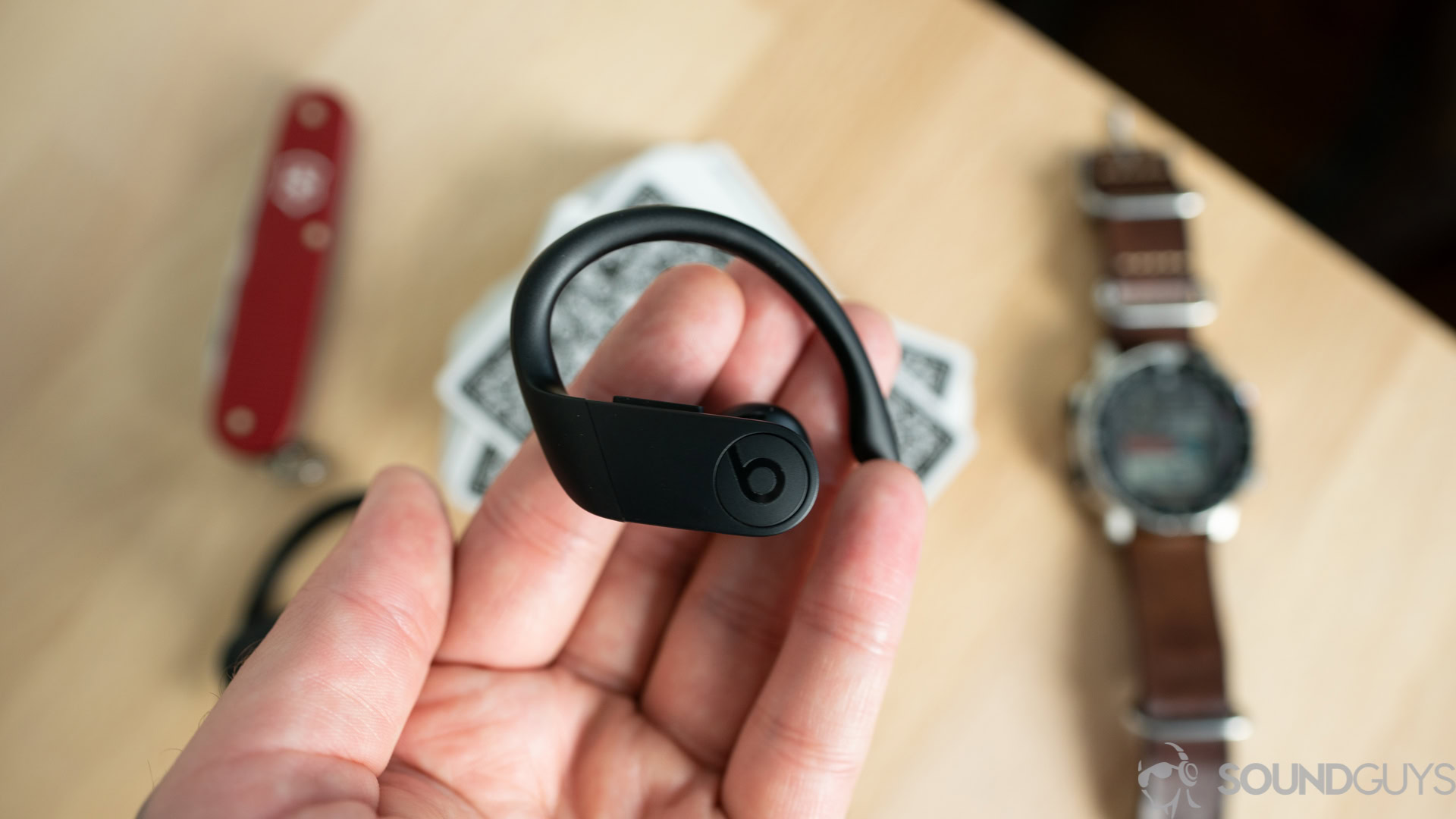 A photo of the Beats Powerbeats Pro in hand.