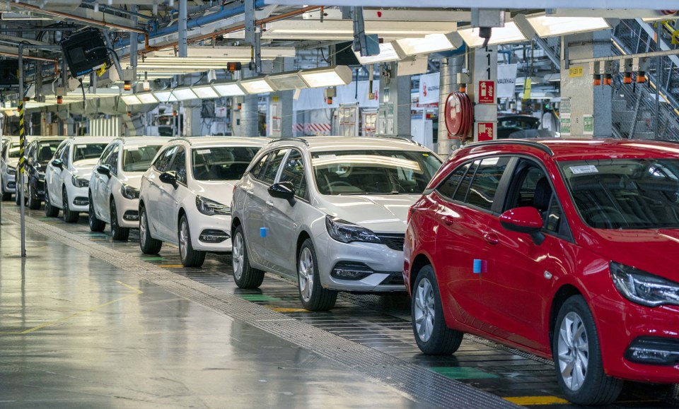 Cars on an assembly line.