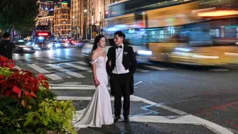 A couple pose for a wedding photo shoot on the Bund in Shanghai