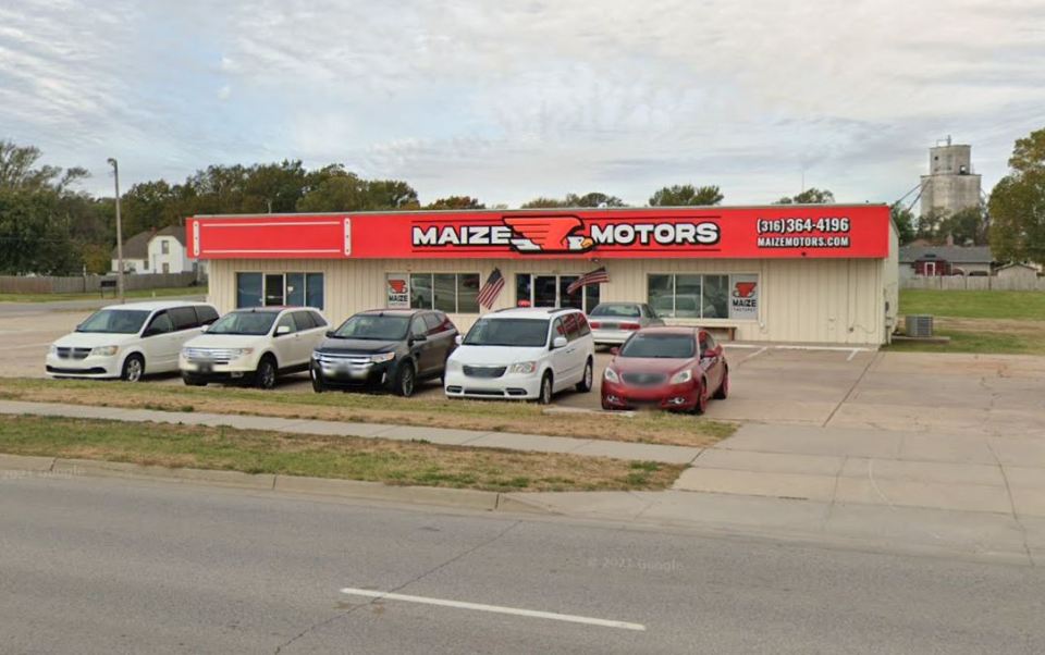 Maize Motors dealership with cars in front.