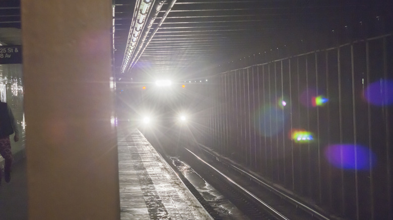 The bright lights of a NYCTA subway track inspection train are seen as the train passes through the West 23rd Street station on Tuesday, March 22, 2016.