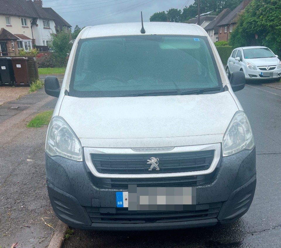 White Peugeot Partner van parked on a residential street.