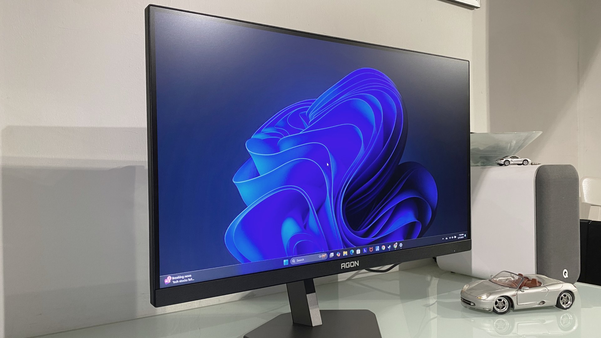 AOC gaming monitor tilted slightly to the side, showing the Windows 11 desktop screen