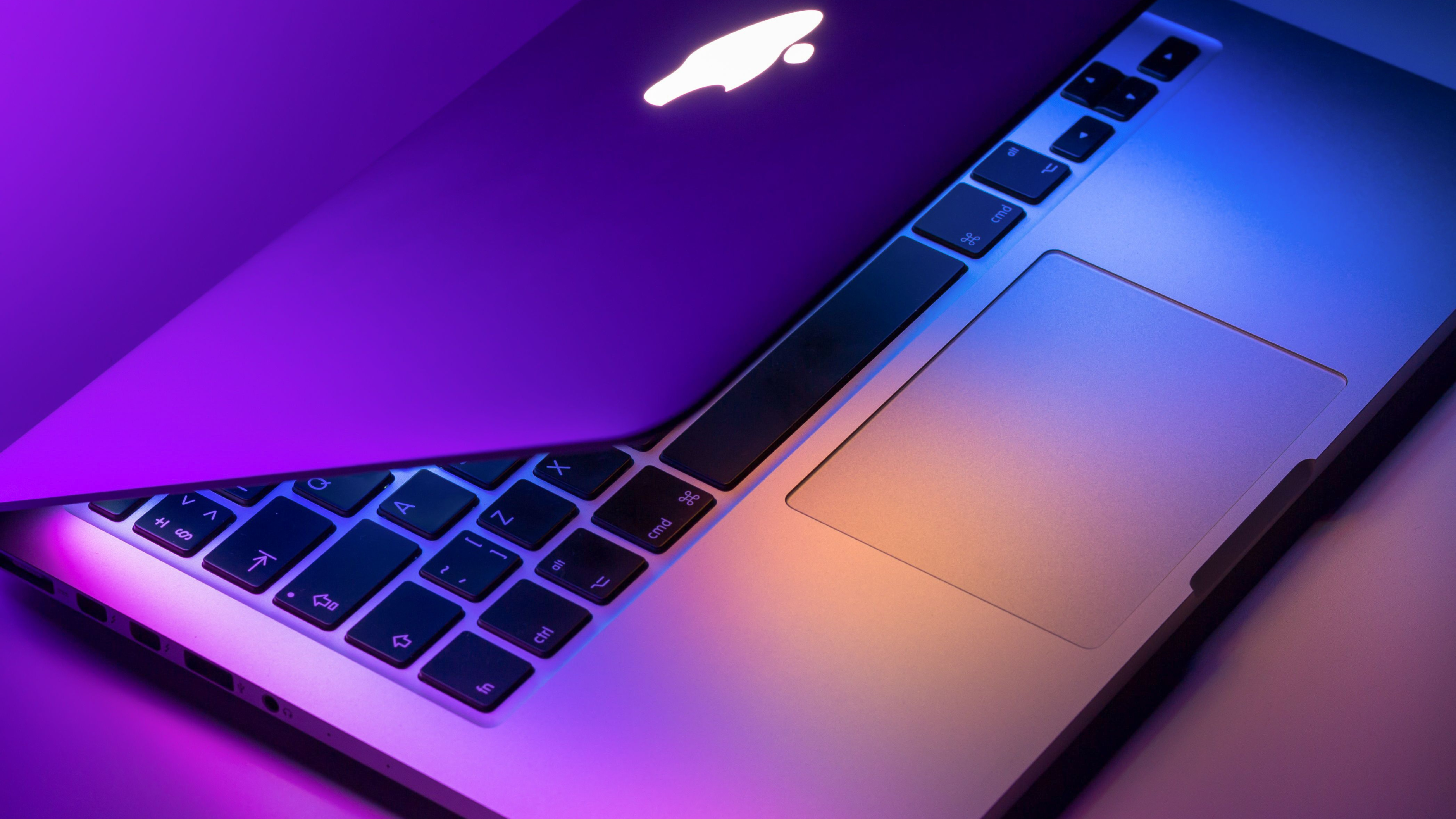 MacBook pro (air) laptop sitting on the desk in a modern futuristic office.