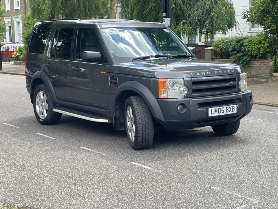 Land Rover Discovery parked on a residential street.