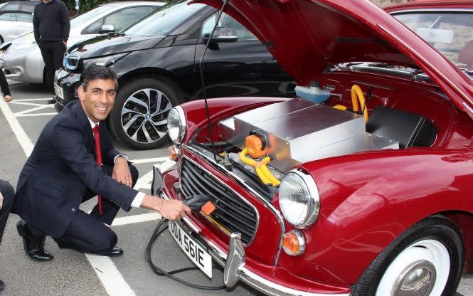 Rishi Sunak charges an electric car