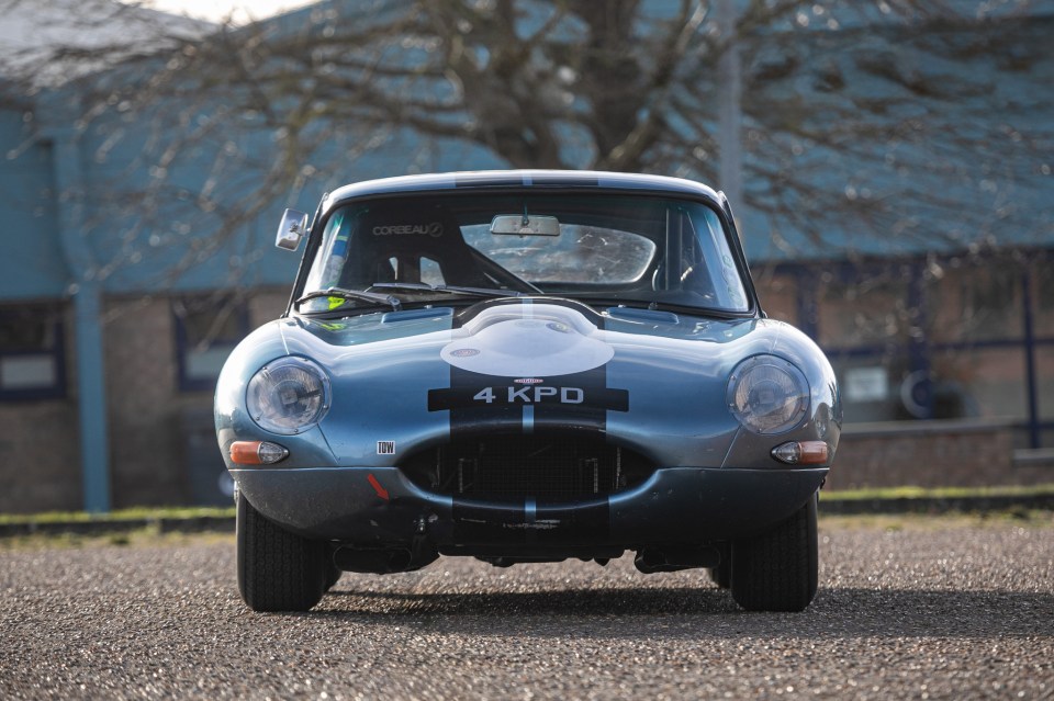 Front view of a blue 1961 Jaguar E-Type 3.8-litre Series 1 FHC race car.