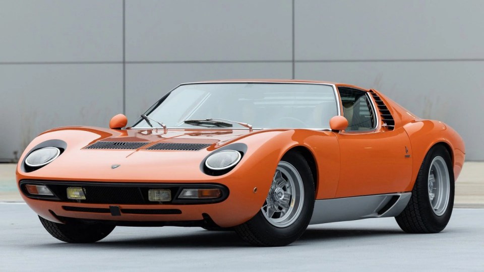 The exterior of the Lamborghini, USA, YOU COULD OWN this rare 1971 Lamborghini Miura P400 SV for ¿4M at auction. Images show this stunning Lamborghini finished in a unique combination of Arancio Miura or Miura Orange paintwork over a retro Goby sand interior. The Miura SV is one of only about 150 of its kind ever built, making it an incredibly rare find for collectors. One of the first 25 cars built, this Miura features early design elements such as the absence of ¿ears¿ on the wheel spinners and bodywork slats with rounded edges, marking it as a distinctive early example of the SV. This particular model is further distinguished by its European specification, devoid of U.S. specific safety features like side repeaters, and it is equipped with a matching numbers chassis and engine. Chassis No. 4854 and Engine No. 30647 trace a fascinating history, beginning with its delivery in July 1971 to Hubert Hahne, a renowned German racing driver and Lamborghini agent. This Miura has an illustrious provenance, having been part of the Rosso Bianco Collection for over three decades, where it shared space with some of the finest sports cars in the world. The car¿s remarkable journey included ownership by notable figures, such as former racing driver Peter Kaus. The meticulous nut-and-bolt restoration took place between 2014 and 2016 and cost close to ¿250K. It was carried out by award-winning Modenese Lamborghini experts, including Carrozzeria Cremonini handling the bodywork and Top Motors working on the mechanicals, alongside other industry leaders. The 1971 Lamborghini Miura P400 SV is set to be auctioned at The Amelia Auction in 2025. ¿The car's striking original colours were briefly altered, as records show it was painted in Luci del Bosco Green before its first private owner, but it has since been restored to its original Miura Orange exterior. "By the early 1980s, the car was acquired by former racing driver and renowned collector Peter Kaus," who added it to his world-famous collection. ¿During this time, the car showed around 60,000 kilometers, believed to be original, before it was sold and carefully restored. "Any Miura SV is a rare motorcar. ¿But an SV such as this, restored to its original and correct specification by the very best craftsmen in Modena, is truly a rare opportunity." ENDS