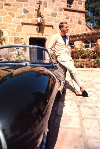 Actor and race-car driver Steve McQueen with his Jaguar XKSS convertible at his Brentwood, Calif.,
home in 1966.