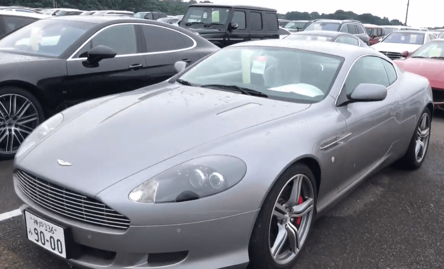 Silver Aston Martin DB9 at a car auction.