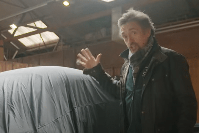 Richard Hammond gesturing towards a covered car.