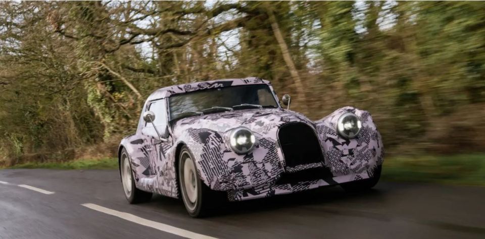 New Morgan car driving on a road.