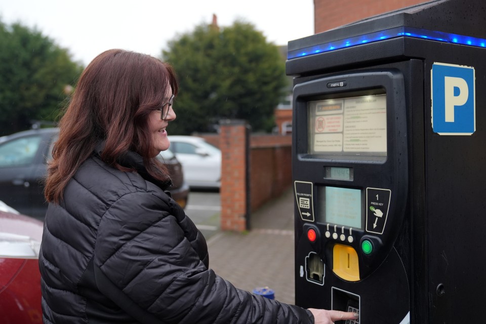 Woman using a parking payment machine.