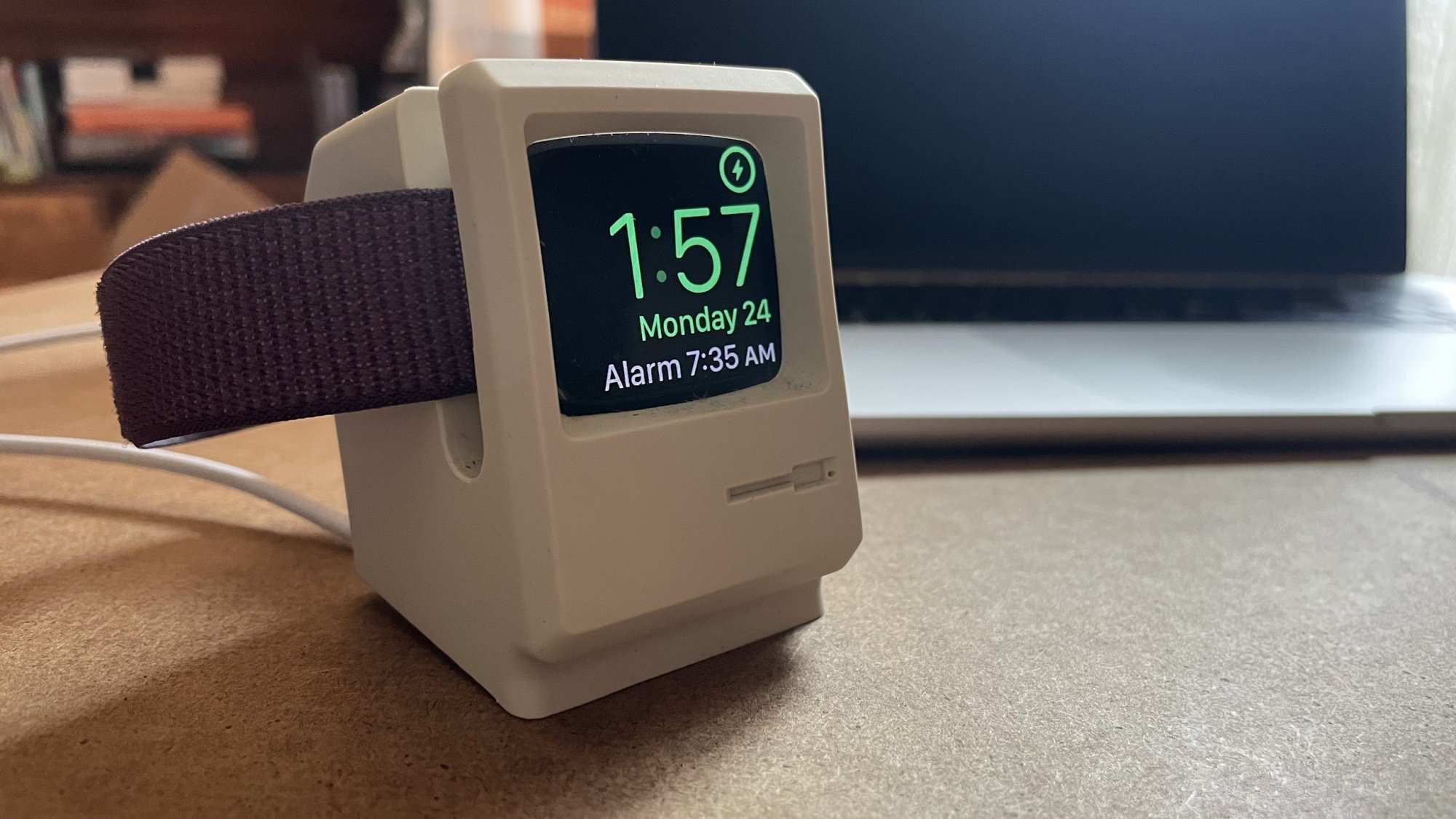 Apple Watch charging in a stand that looks like a 1980s Mac computer