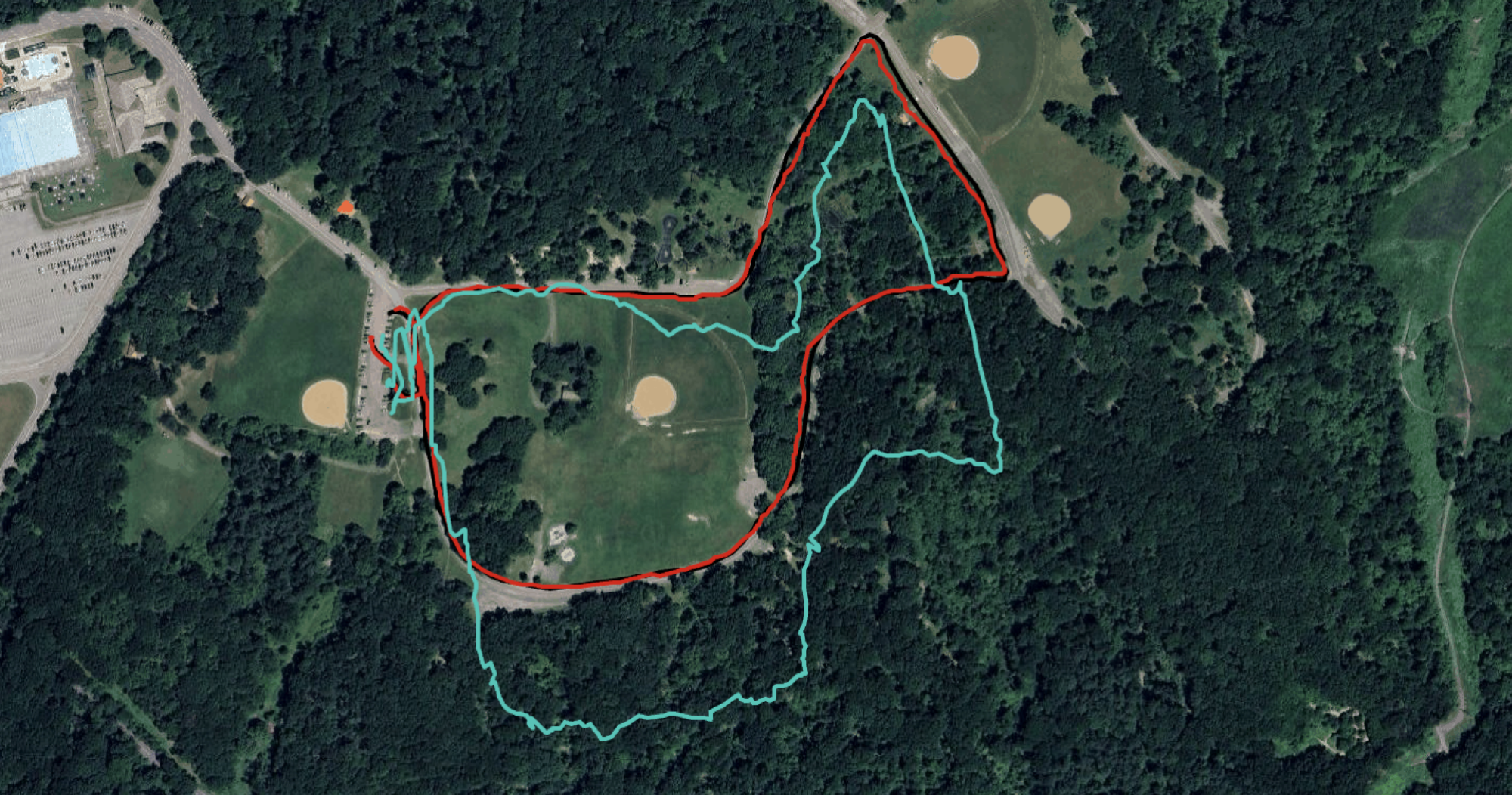 Three GPS tracks on a satellite view of a park. The aqua track (Fitbit) is offset from the others and stretched out.Looks super weird.