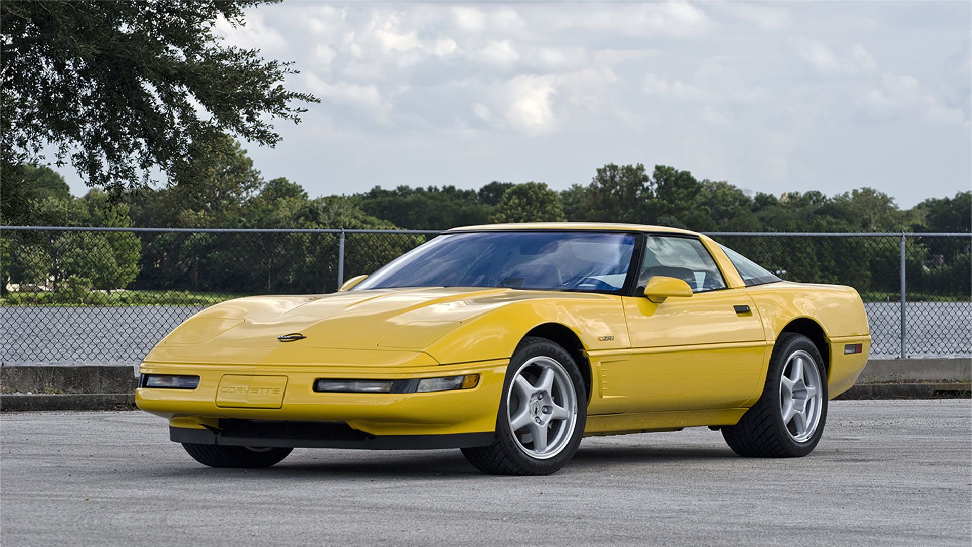 A yellow 1995 Chevrolet Corvette C4 with silver rims