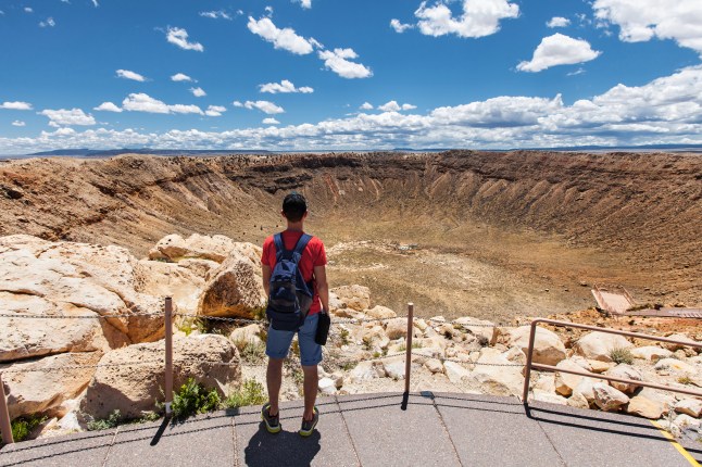 A hiker with backpack enjoying view, Winslow, Arizona, USA