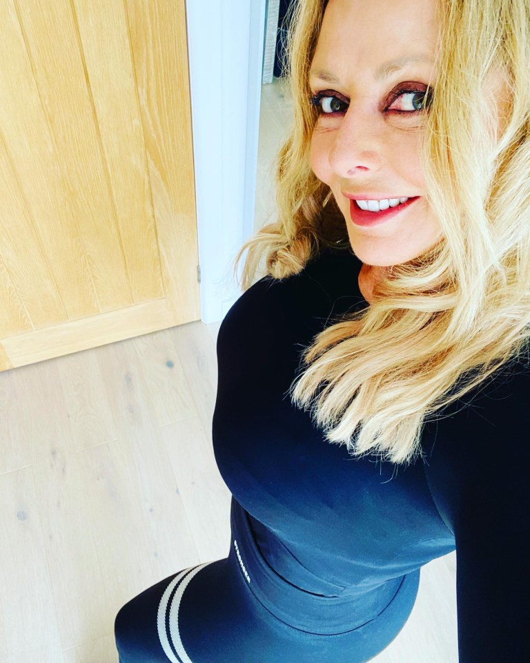 Carol Vorderman in black workout clothes.