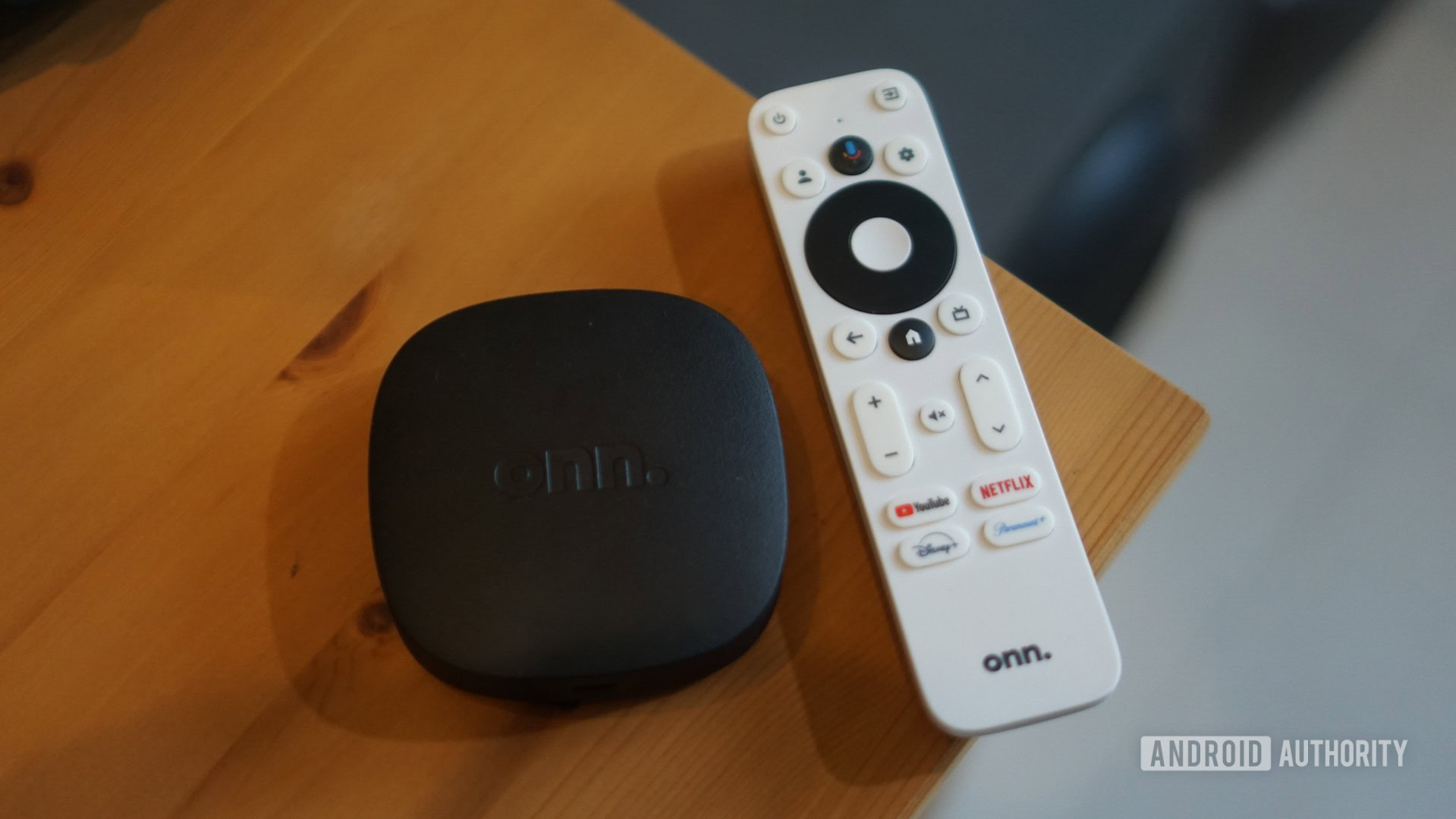 onn 4k box with remote next to it