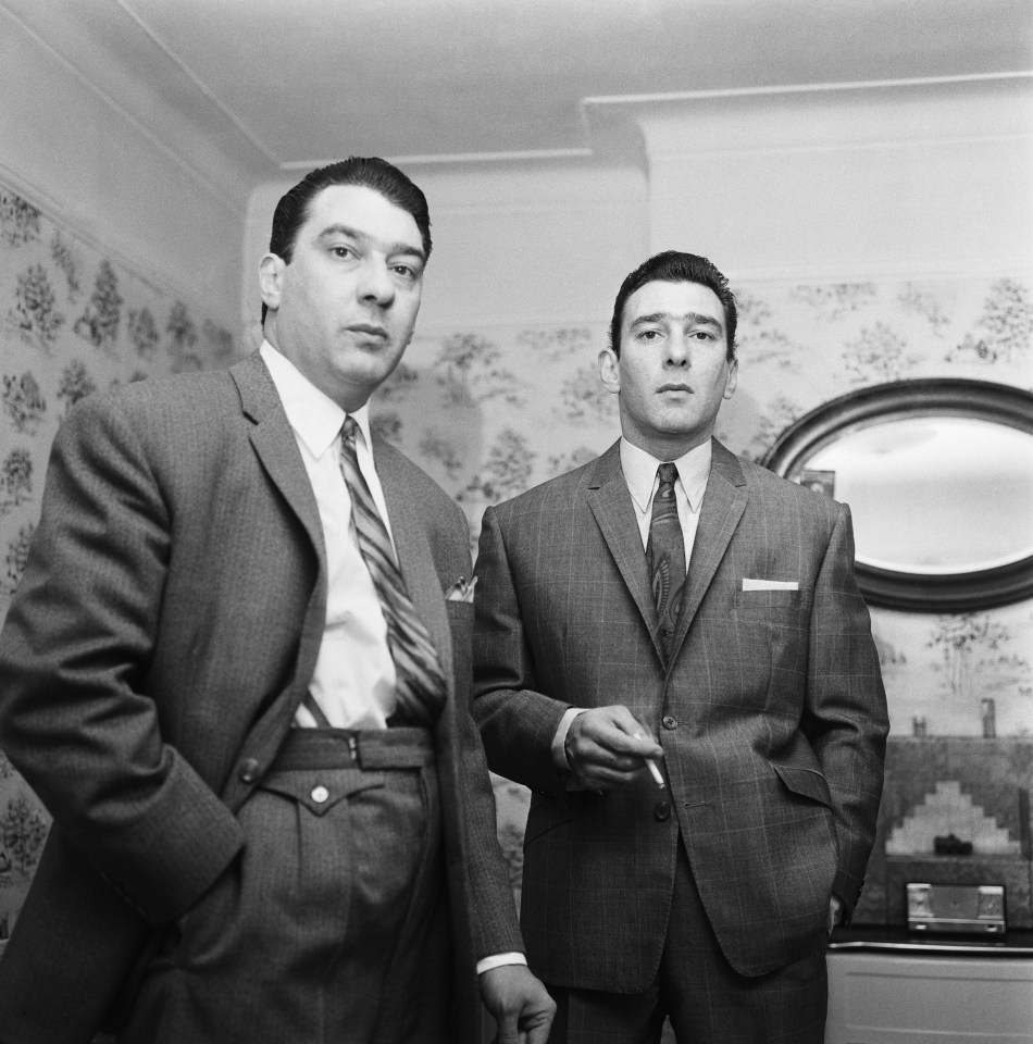 Black and white photo of the Kray twins, Ronald and Reginald, at home.