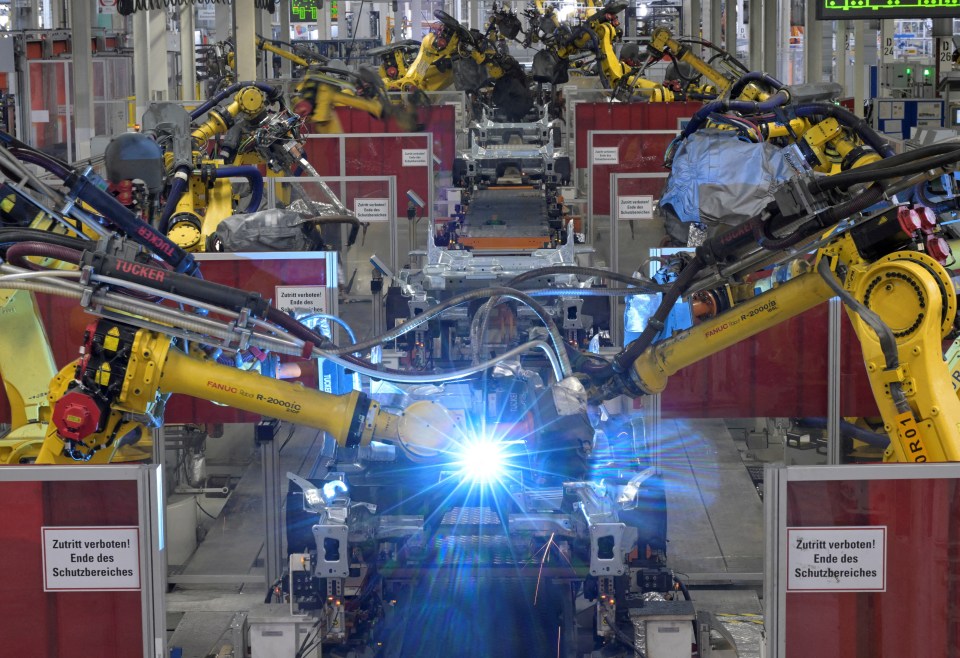 Welding robots assembling Volkswagen Golf VIII and Tiguan cars.