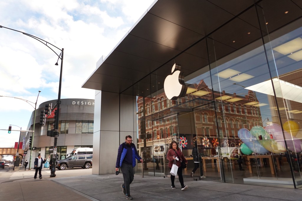 People walking outside an Apple store