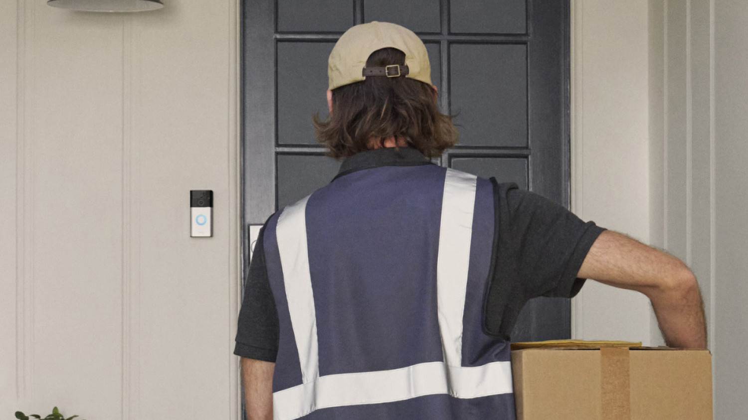 Mail man leaving package with Ring Battery Doorbell